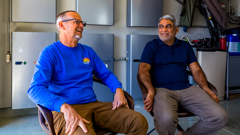 Brian and Vishnu chat about the benefits of solar and storage, with Enphane IQ batteries in the background